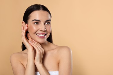 Photo of Portrait of attractive young woman on beige background, space for text. Spa treatment