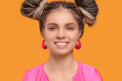 Photo of Beautiful woman with braided double buns on yellow background