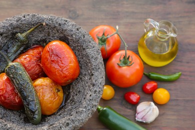 Ingredients for tasty salsa sauce and stone bowl on wooden table, flat lay