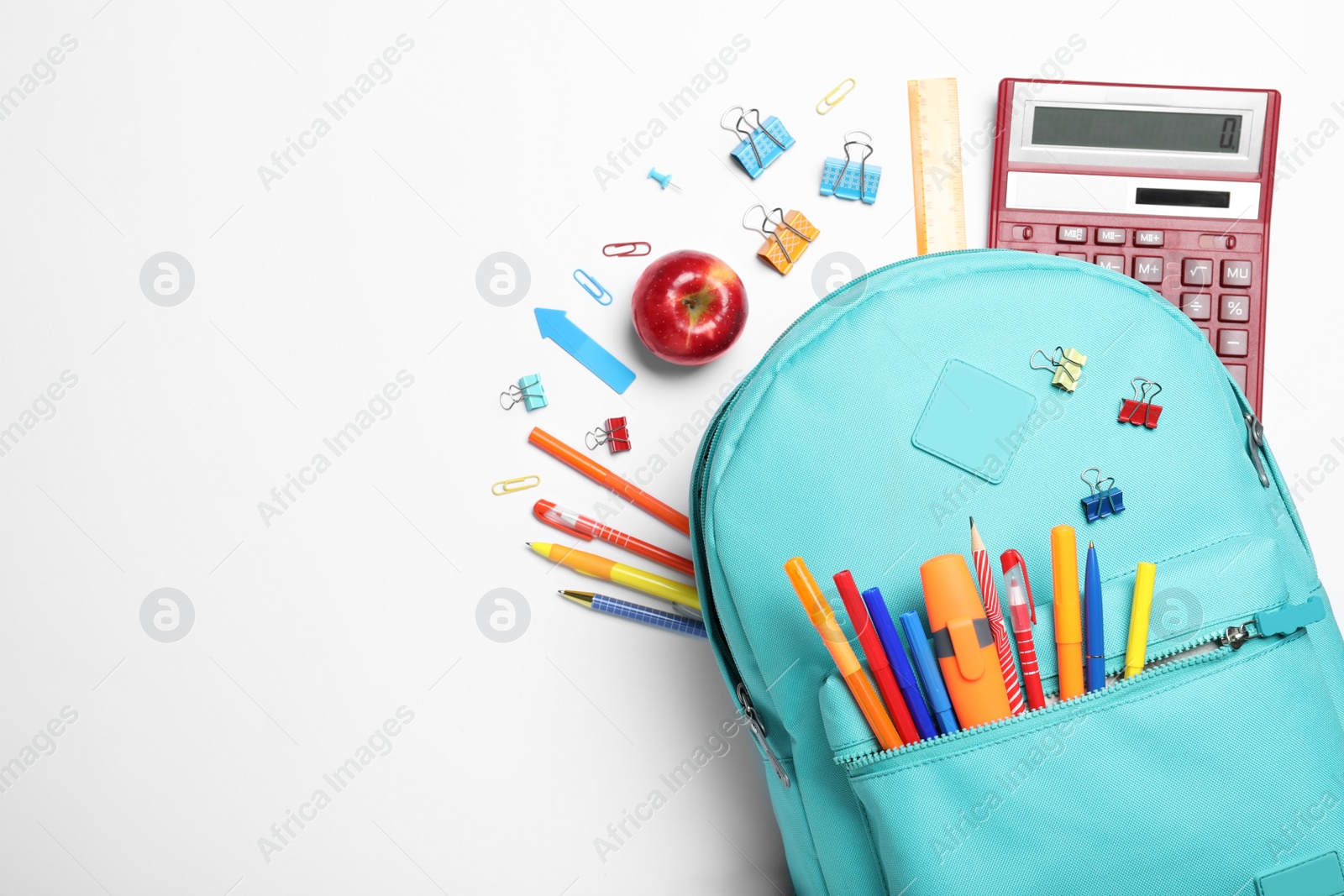 Photo of Stylish backpack with different school stationery on white background, top view