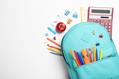 Photo of Stylish backpack with different school stationery on white background, top view