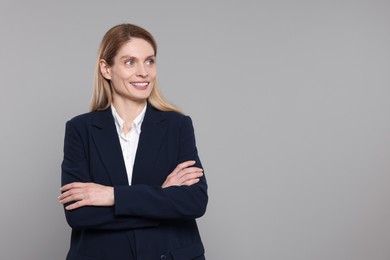 Photo of Happy real estate agent on grey background. Space for text