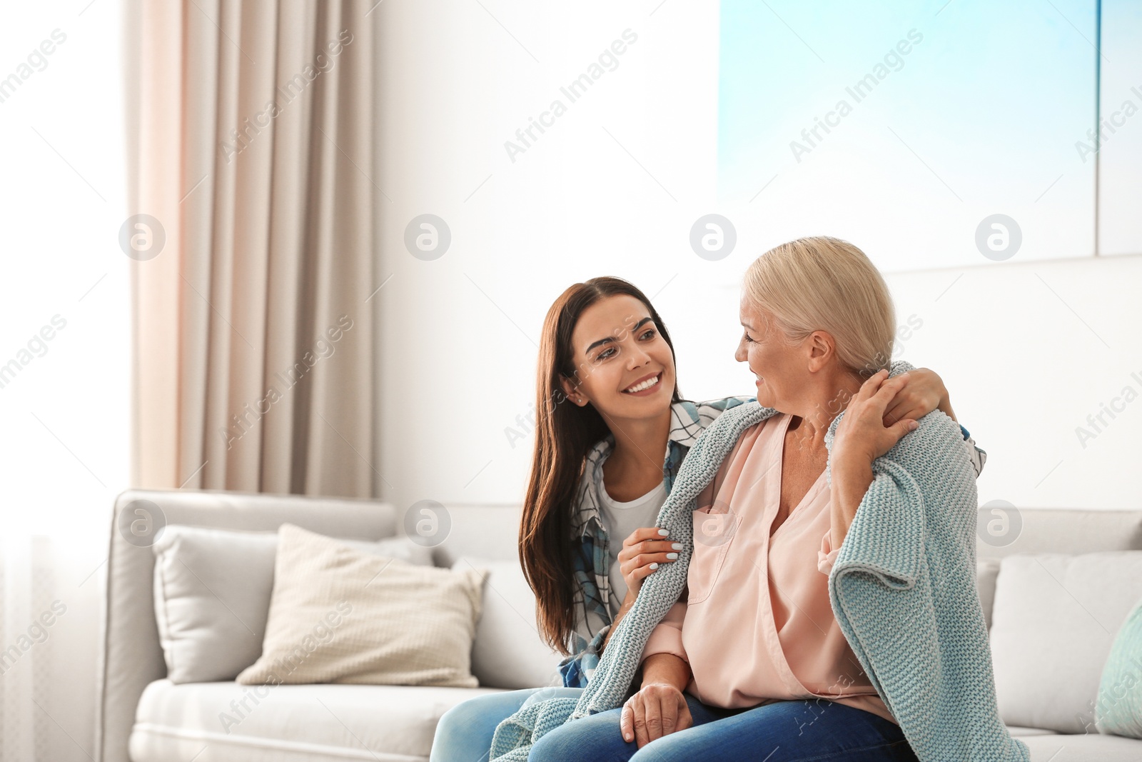 Photo of Daughter taking care of her mother at home. Help concept