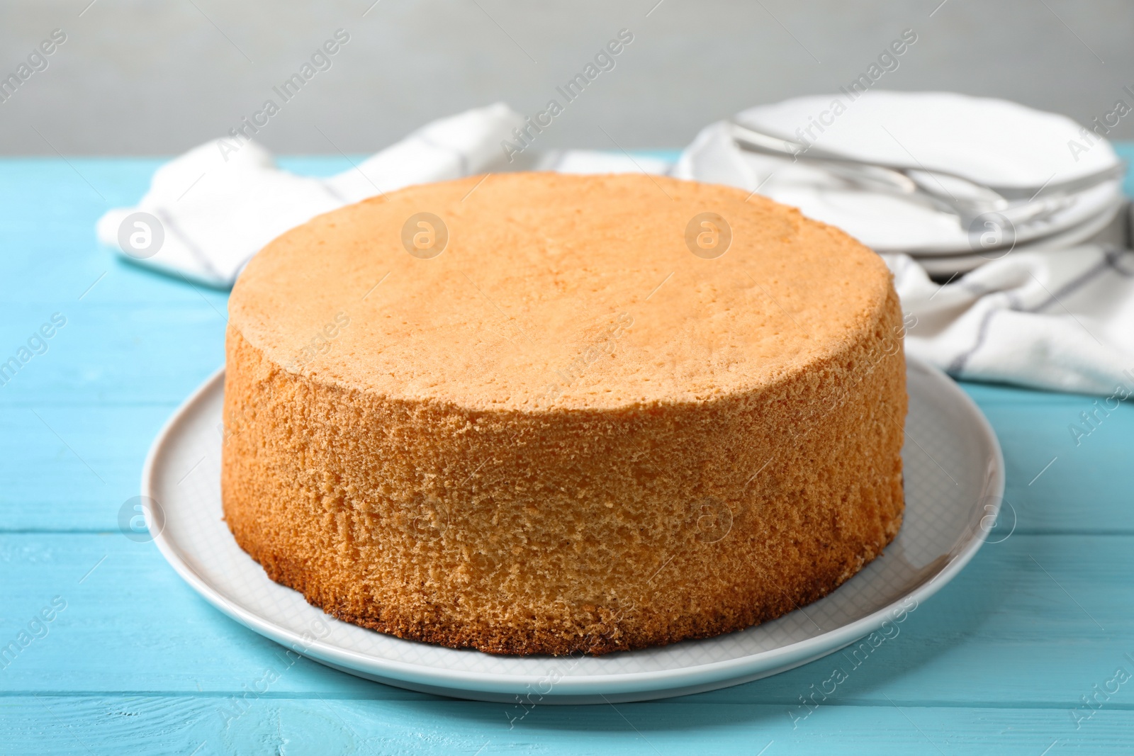 Photo of Delicious fresh homemade cake on light blue wooden table