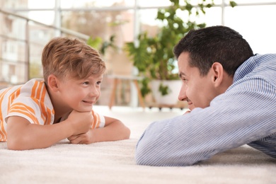 Photo of Father with cute child on floor at home. Happy family