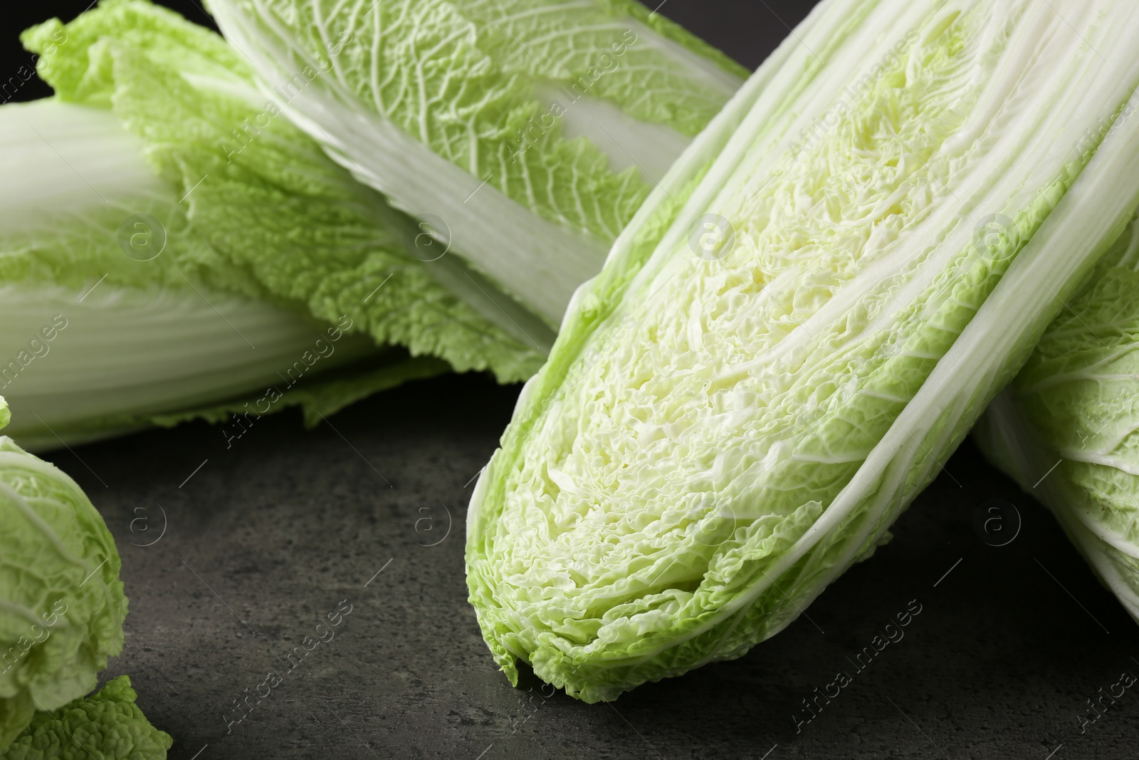 Photo of Fresh ripe Chinese cabbages on grey table, closeup