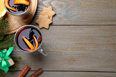 Photo of Flat lay composition with aromatic mulled wine on wooden table, space for text