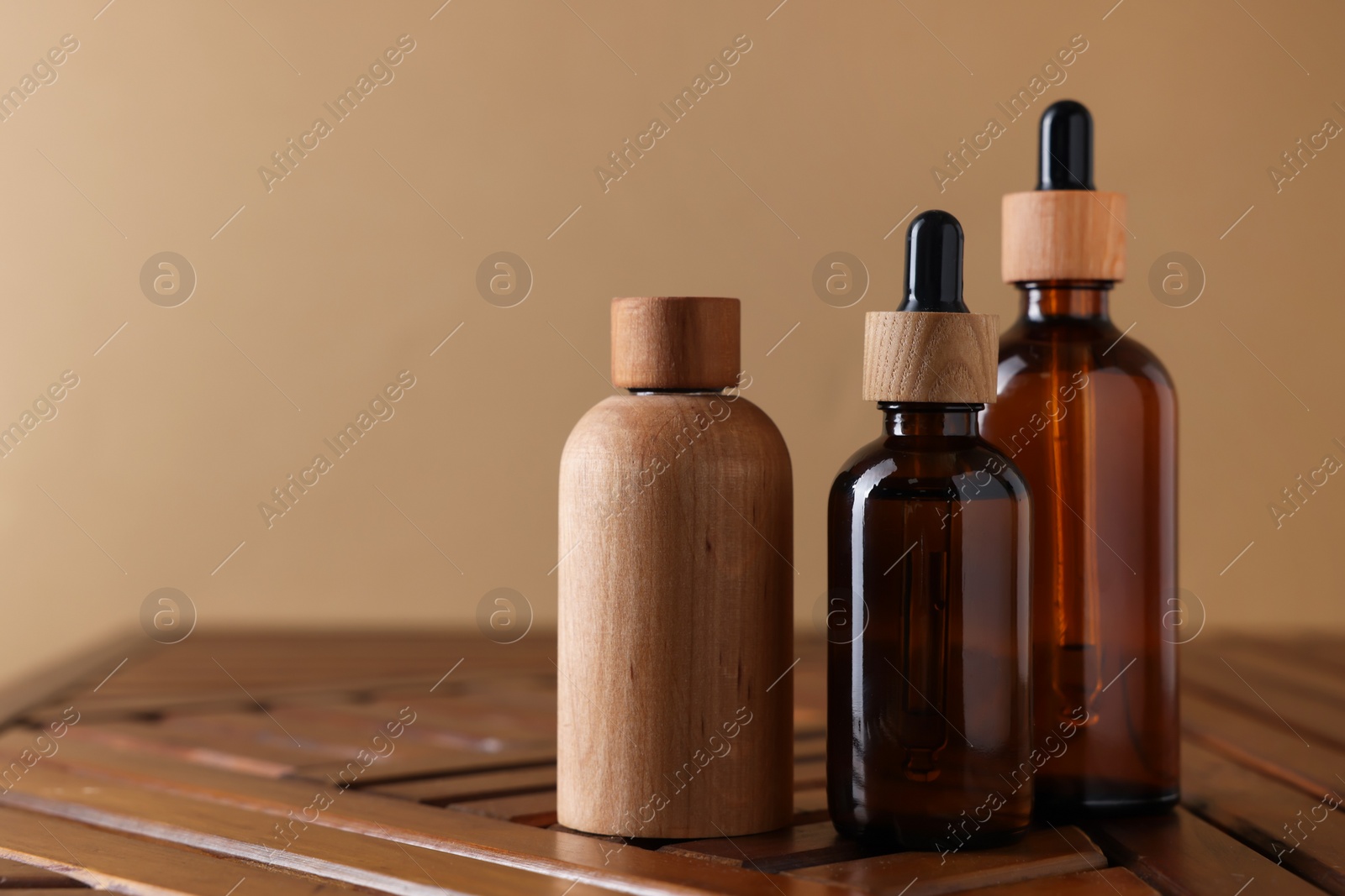 Photo of Set of different luxury cosmetic products on wooden table, space for text