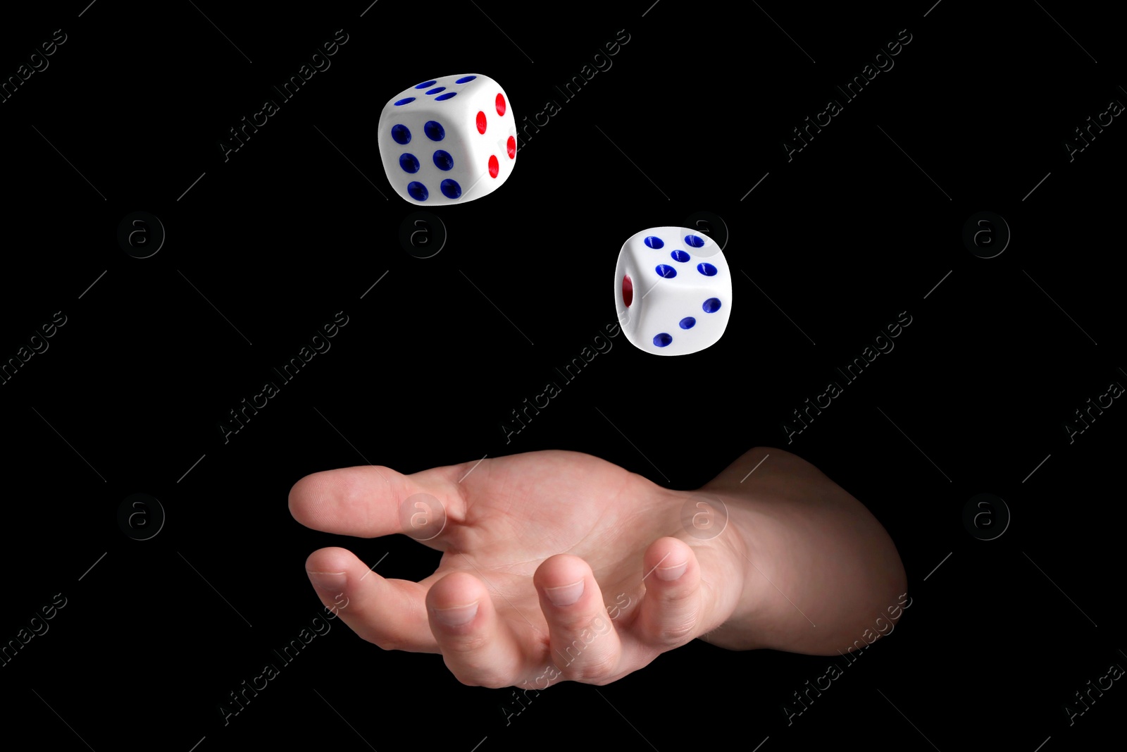 Image of Man throwing white dice on black background, closeup