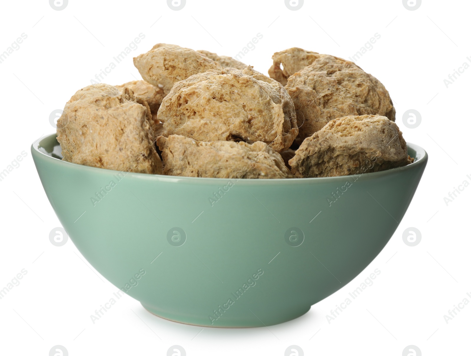 Photo of Dehydrated soy meat chunks in bowl on white background