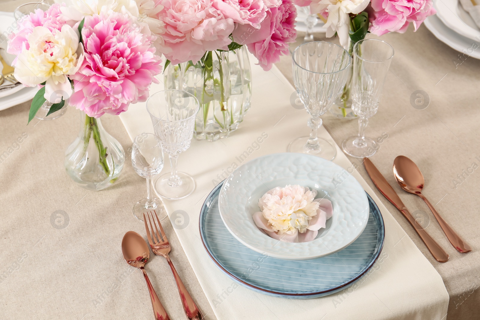 Photo of Stylish table setting with beautiful peonies and golden cutlery