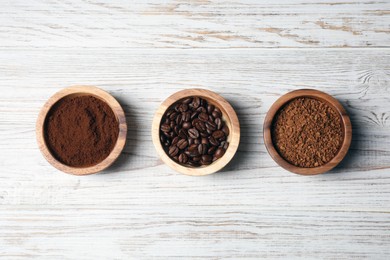 Photo of Instant, ground coffee and roasted beans on white wooden table, flat lay