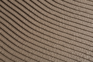 Photo of Lined grey concrete as background, top view. Tile installation