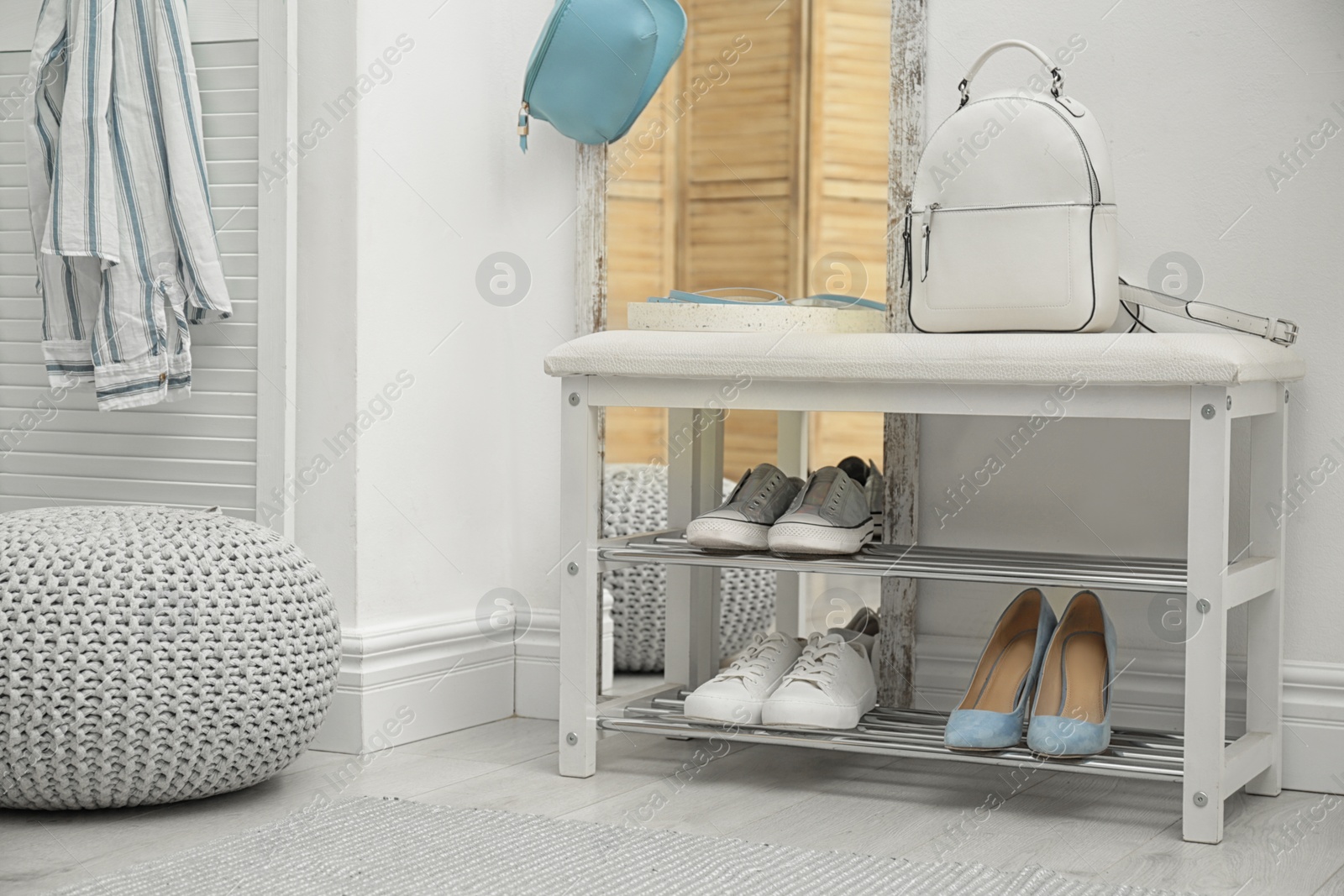 Photo of Stylish hallway interior with storage bench near light wall