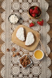Photo of Delicious ricotta bruschettas and products on wooden table, flat lay