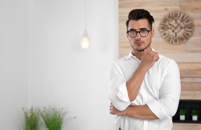 Portrait of handsome young man in room