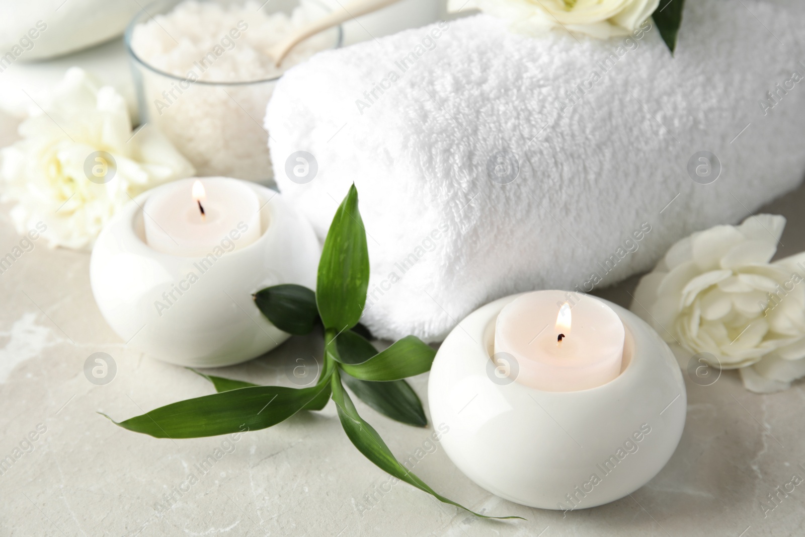 Photo of Beautiful spa composition with candles and flowers on table