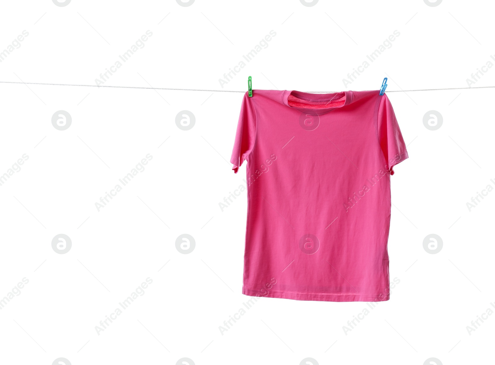 Photo of Pink t-shirt drying on washing line against white background