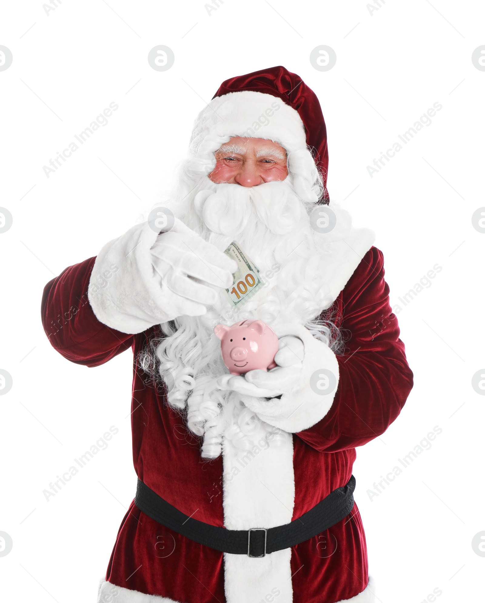 Photo of Santa Claus putting dollar banknote into piggy bank on white background