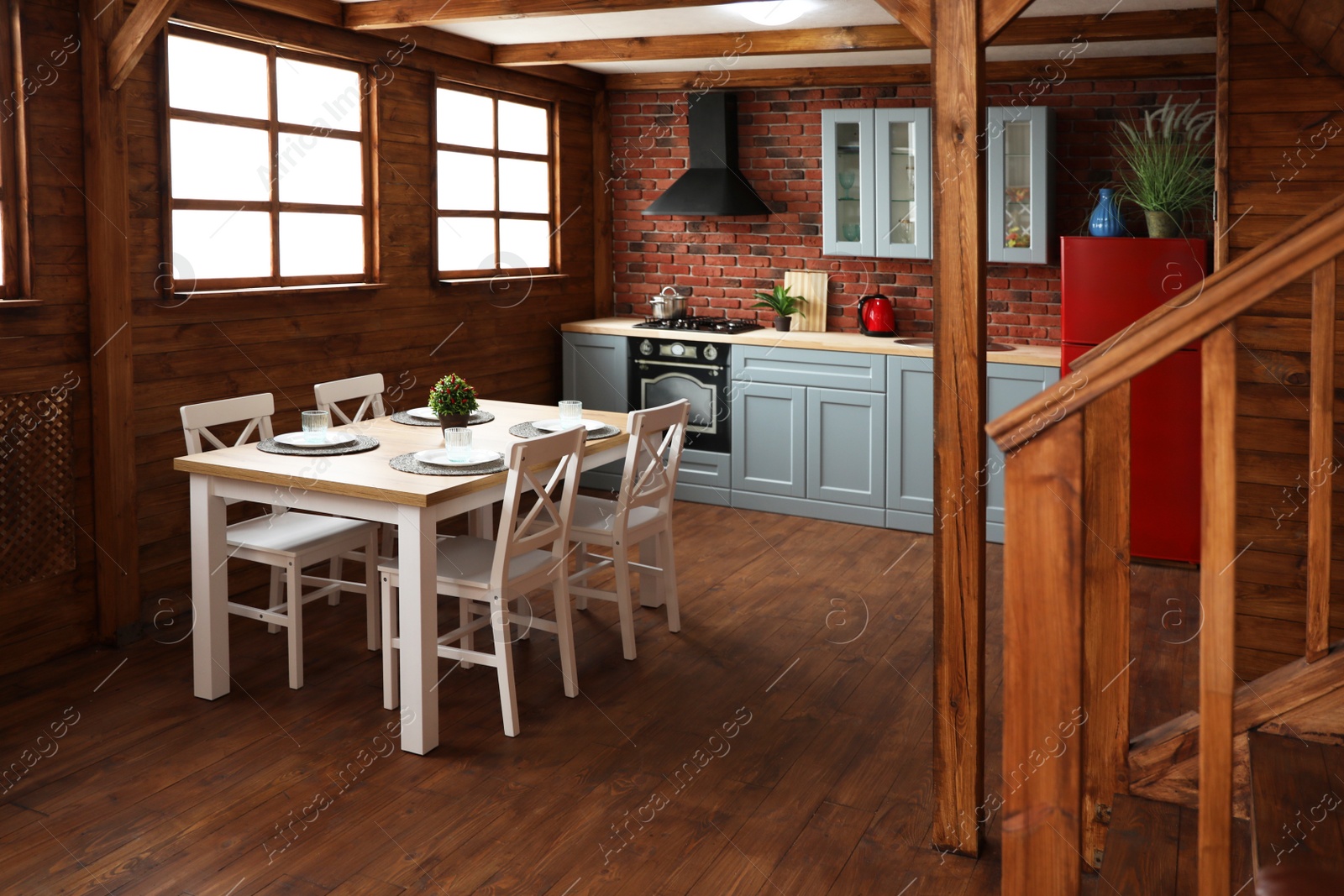 Photo of Stylish kitchen interior with wooden table and chairs