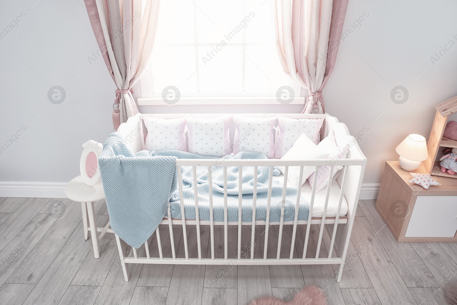 Photo of Baby room interior with comfortable crib