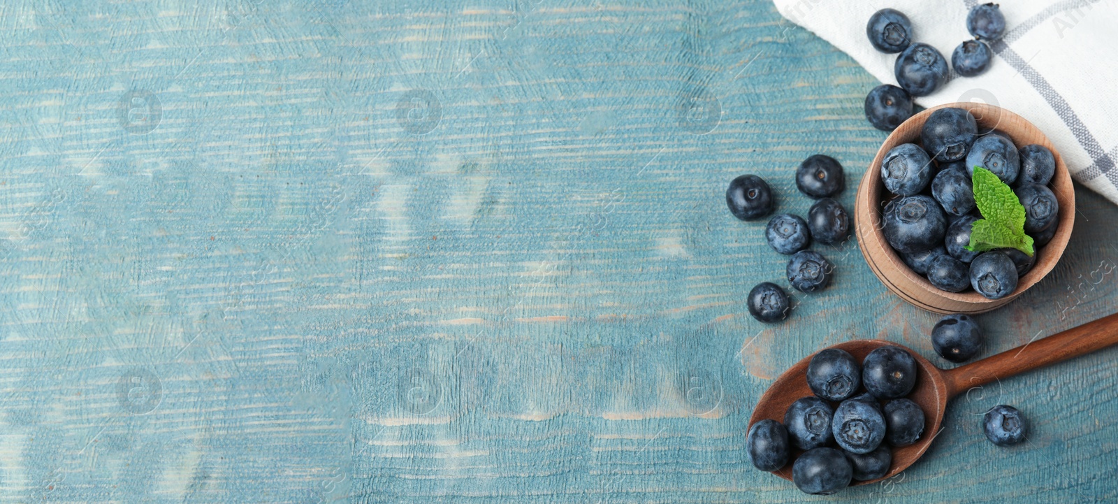 Image of Tasty fresh blueberries on wooden table, flat lay with space for text. Banner design