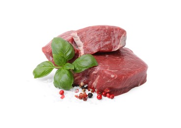 Fresh beef meat with basil leaves and spices isolated on white