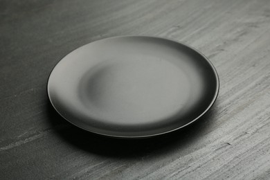 Beautiful ceramic plate on black table, closeup