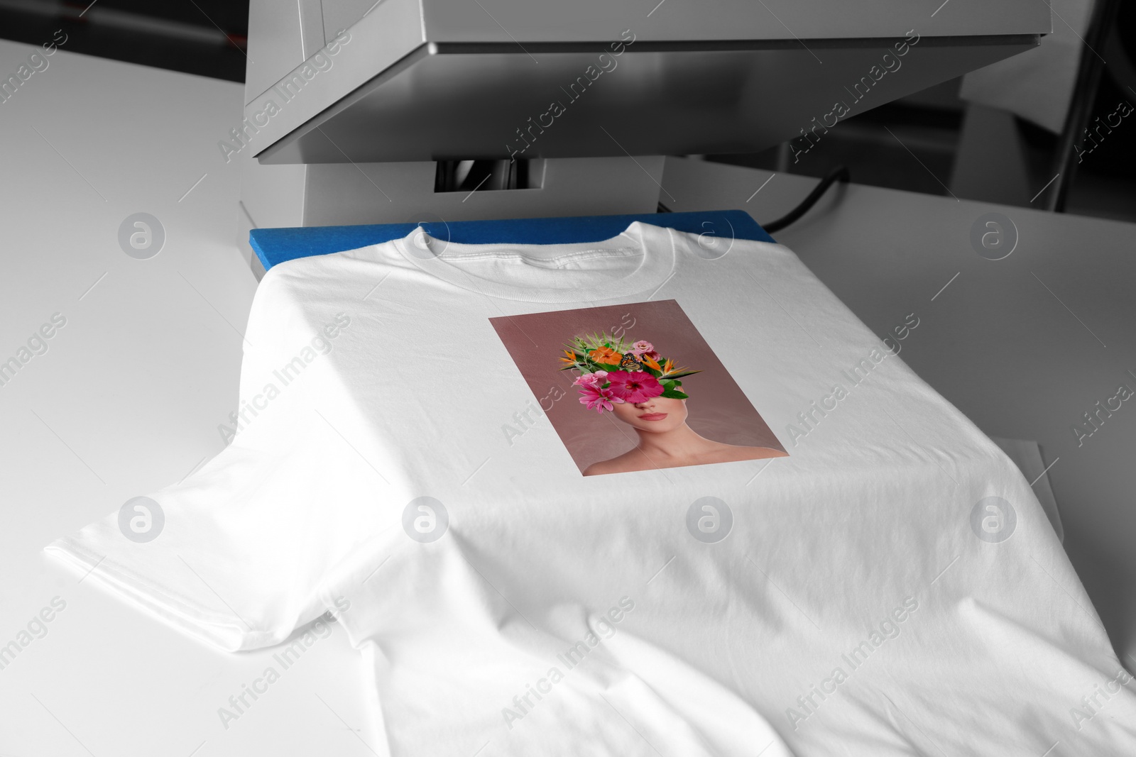 Image of Custom t-shirt. Using heat press to print creative image of woman with beautiful flowers