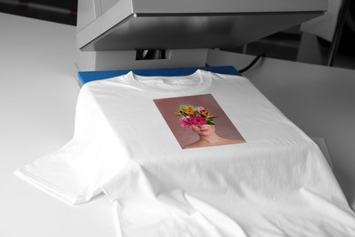 Image of Custom t-shirt. Using heat press to print creative image of woman with beautiful flowers