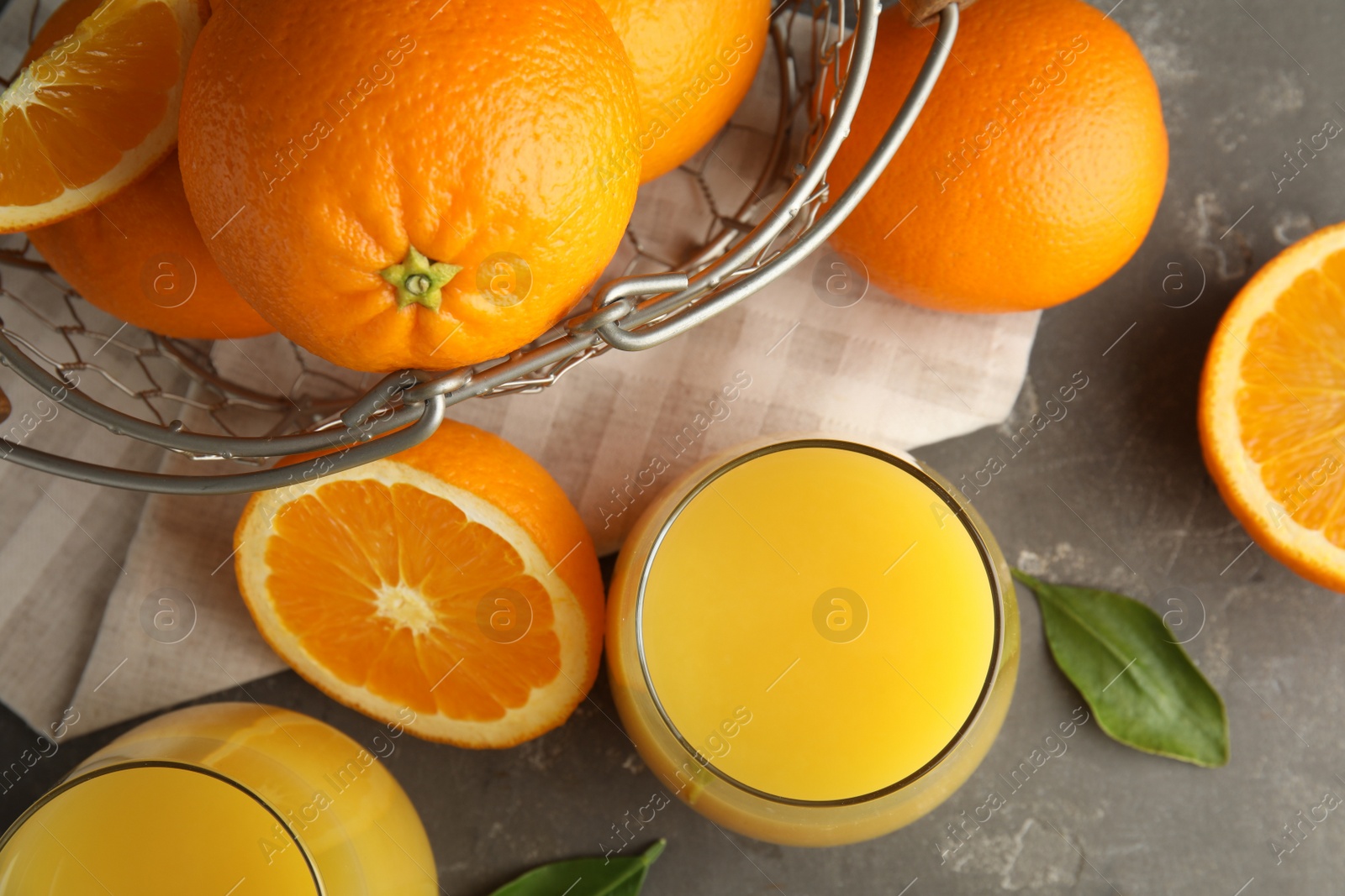 Photo of Flat lay composition with orange juice and fresh fruit on grey background