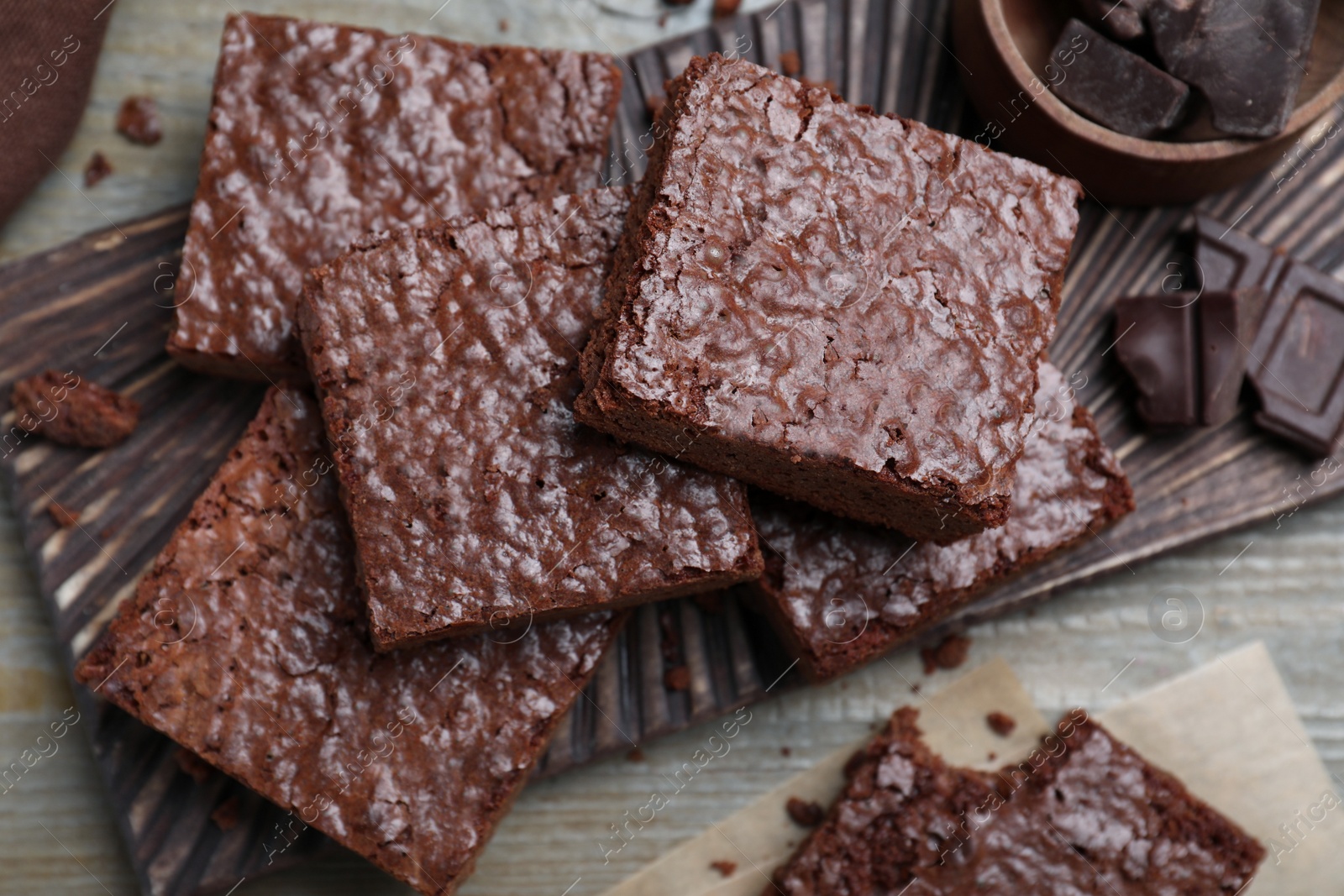 Photo of Delicious chocolate brownies on wooden table, flat lay