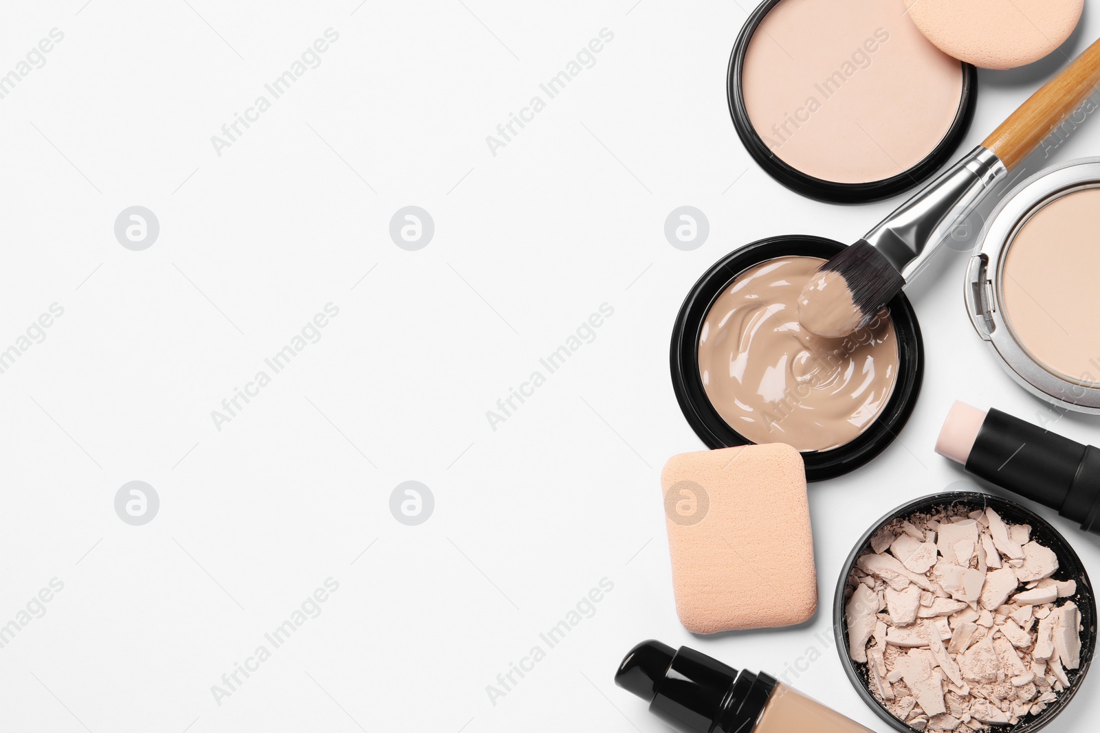 Photo of Foundation, beauty accessories and face powders on white background, flat lay. Space for text