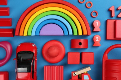 Different children's toys on blue background, flat lay