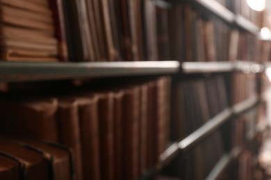 Blurred view of books on shelves in library