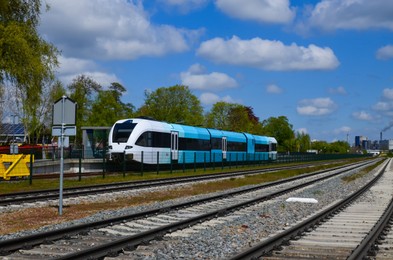 Photo of Railway lines and modern train on sunny day