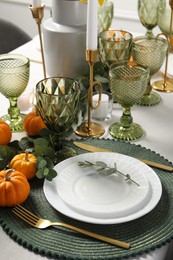 Photo of Beautiful autumn table setting. Plates, cutlery, glasses, pumpkins and floral decor