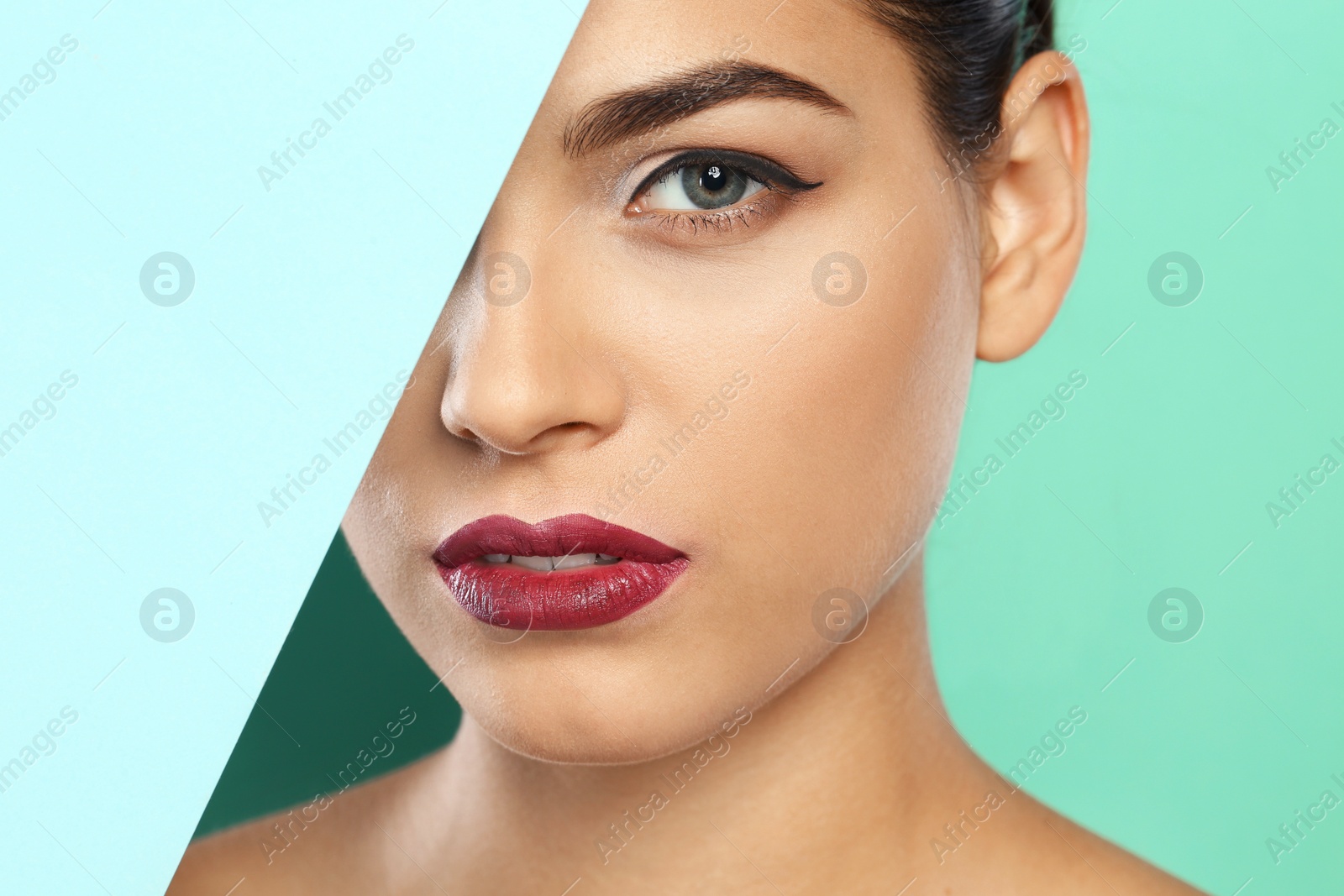 Photo of Young woman wearing beautiful lipstick on color background