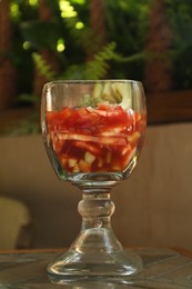 Photo of Delicious campechana cocktail with fresh ingredients on table