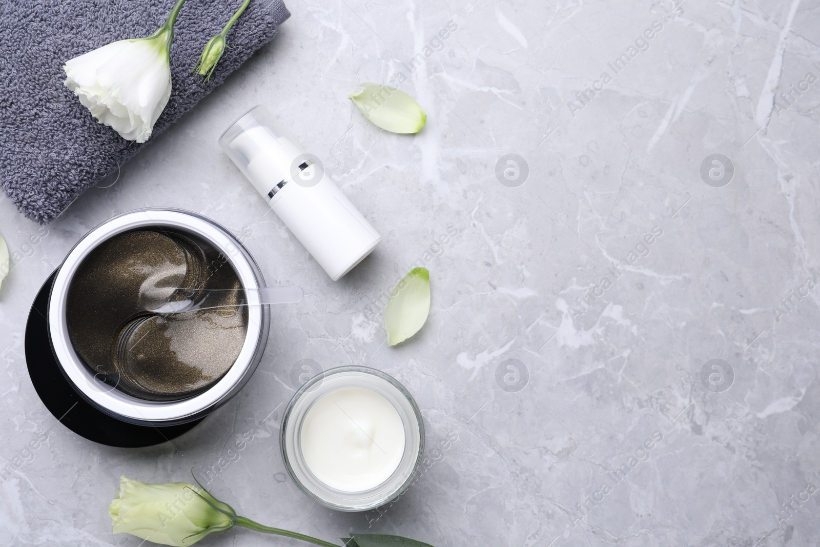 Photo of Flat lay composition with under eye patches on light grey marble table, space for text. Cosmetic product