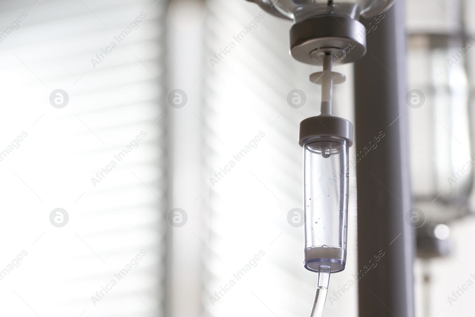 Photo of IV drip against blurred background, space for text