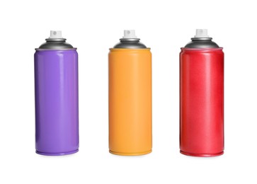 Photo of Cans of different spray paints on white background. Graffiti supplies