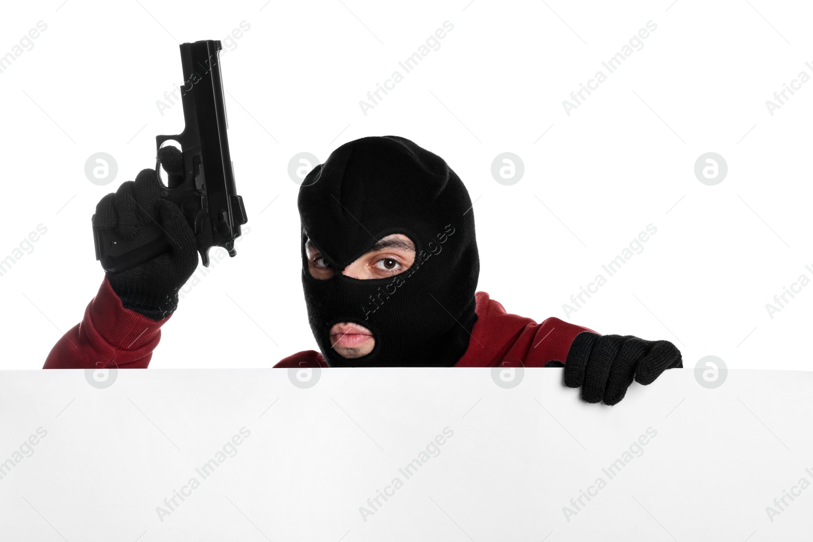 Photo of Thief in balaclava with gun on white background