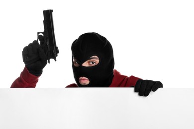 Photo of Thief in balaclava with gun on white background