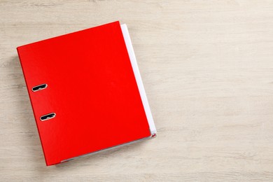 Photo of Red office folder on white wooden table, top view. Space for text