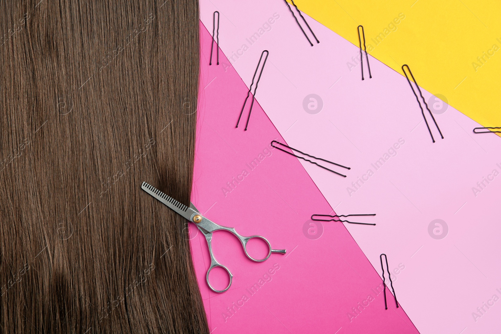 Photo of Flat lay composition with brown hair, scissors and pins on color background