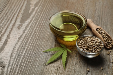 Composition with hemp oil on wooden table. Space for text