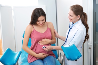 Pregnant woman having appointment at gynecologist office