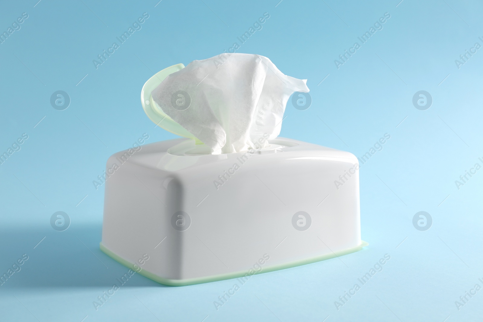 Photo of Box of paper tissues on light blue background