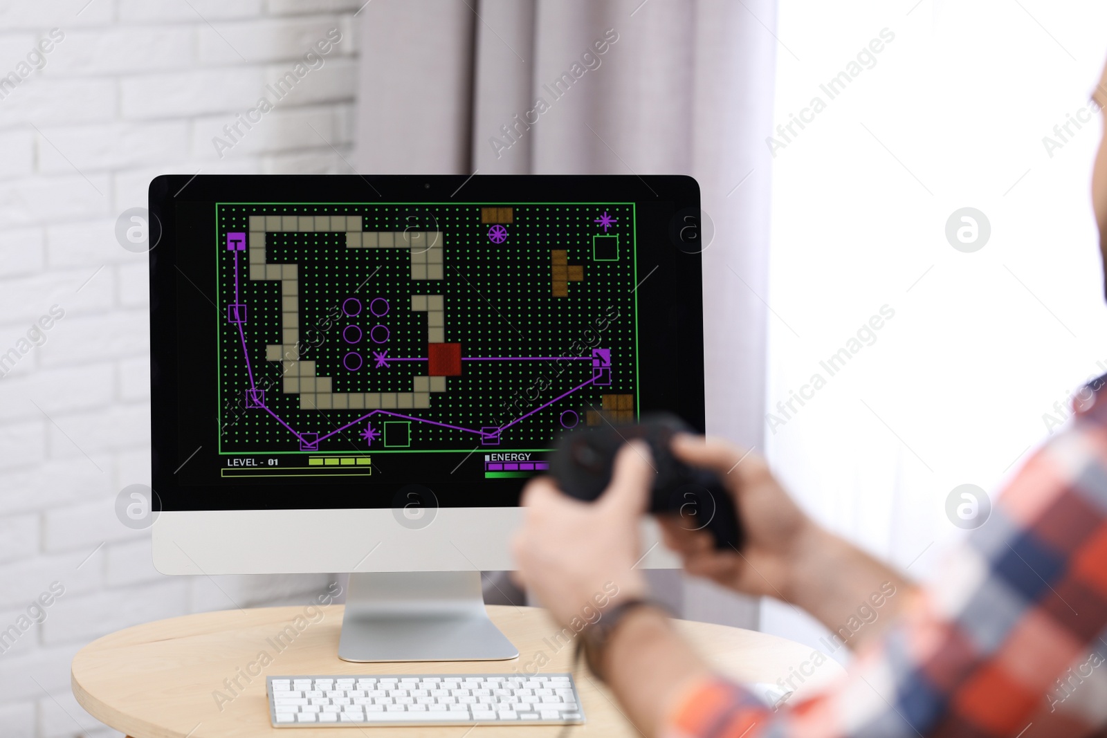 Photo of Young man playing video game at home, closeup